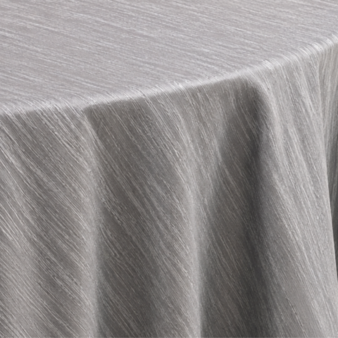 TABLECLOTH SILVER TWIST ROUND 132inD CELEBRATIONS GRAND CAYMAN RENTAL PARTY EVENTS CUSHION SILVER SATIN 20IN X 20INCUSHION ORANGE GEOMETRIC DESIGN 18IN X 18INTABLECLOTH SILVER TWIST ROUND 132inD