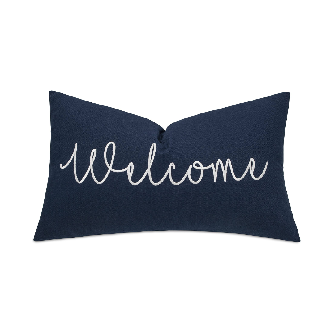 Image showcasing a 12-inch by 20-inch navy blue cushion with embroidered 'Welcome' message, radiating hospitality and charm, ideal for adding a warm touch to home or event decor.