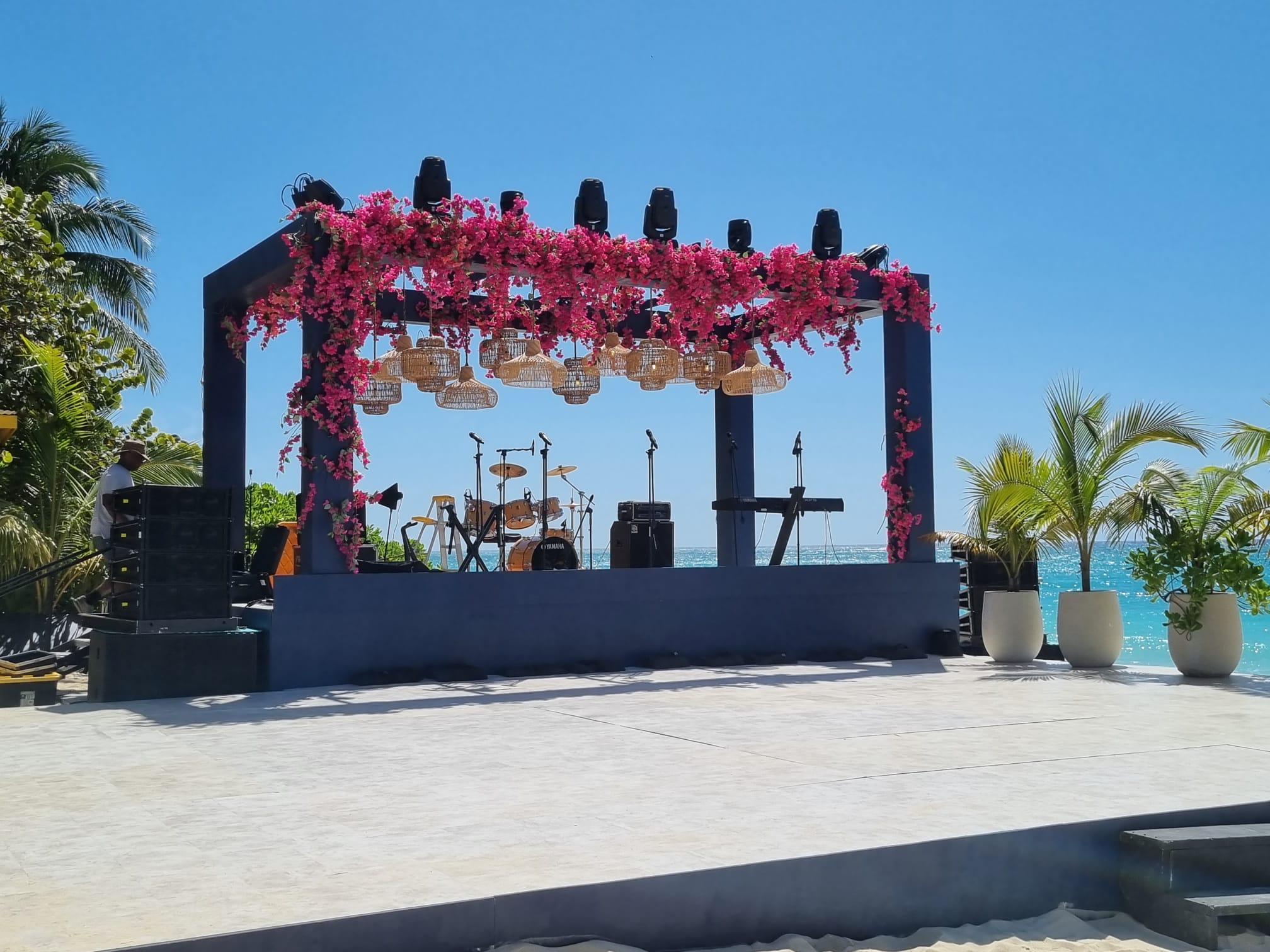 An image showing a stage design adorned with bougainvillea for a wedding party 