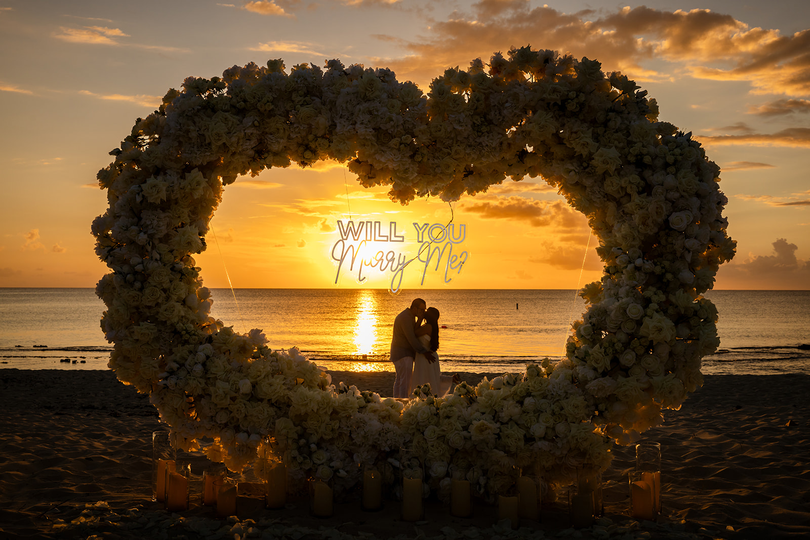 Valentine’s Day 2026 sunset beach wedding proposal on Seven Mile Beach Cayman with candles, roses, and romantic ocean backdrop