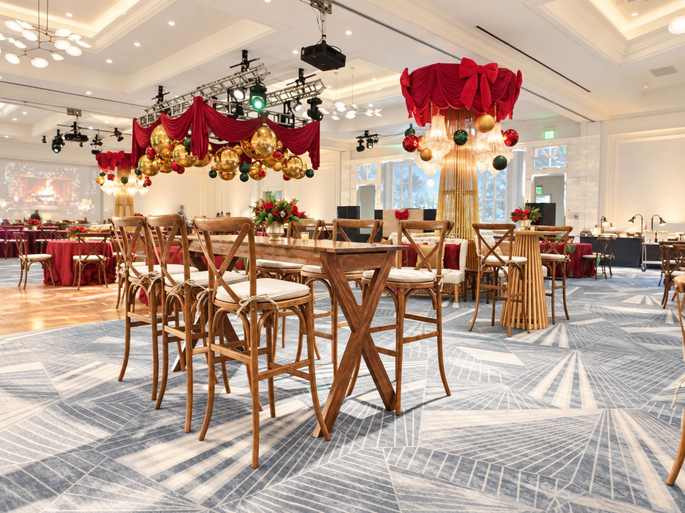 Elegant Christmas holiday party setup featuring wooden dining tables and chairs, dramatic red draping, oversized gold ornaments, chandeliers, and festive décor in a modern ballroom.
